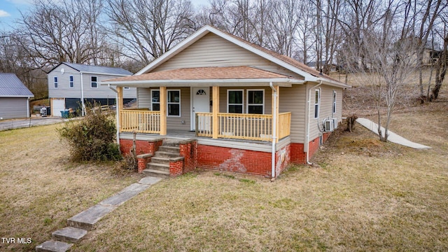 bungalow featuring a porch and a front lawn