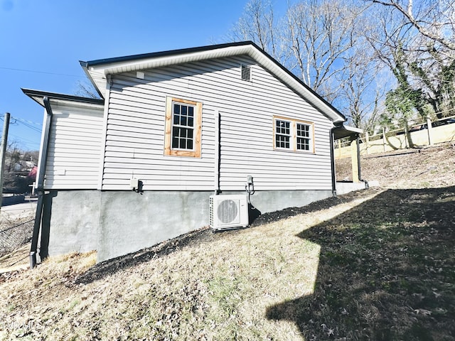 view of side of property with ac unit