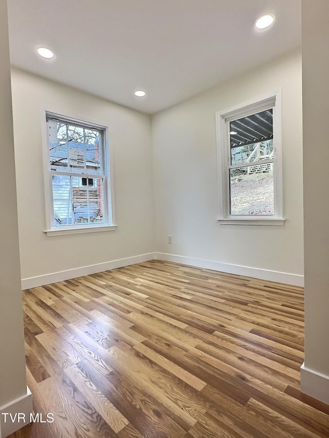 unfurnished room with wood-type flooring