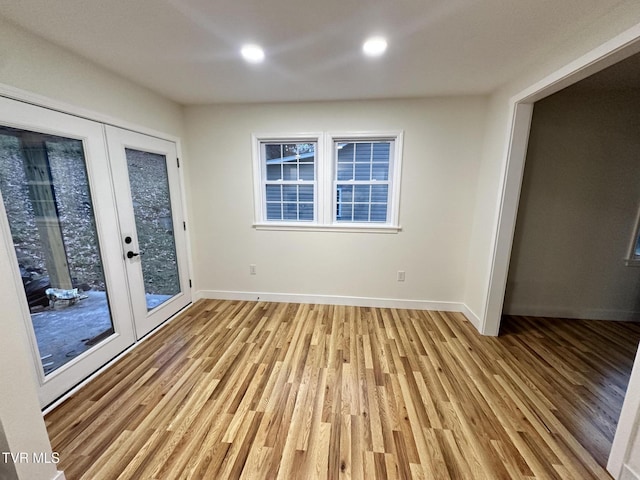 unfurnished room featuring light hardwood / wood-style flooring and french doors