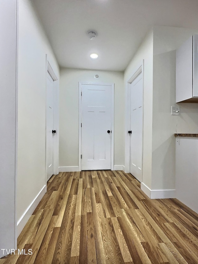 corridor featuring hardwood / wood-style floors