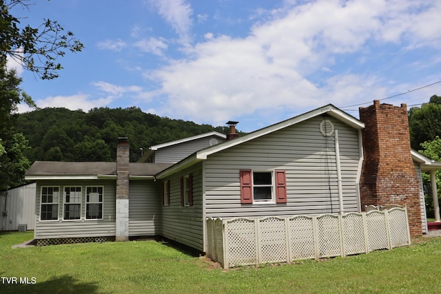 rear view of house with a lawn