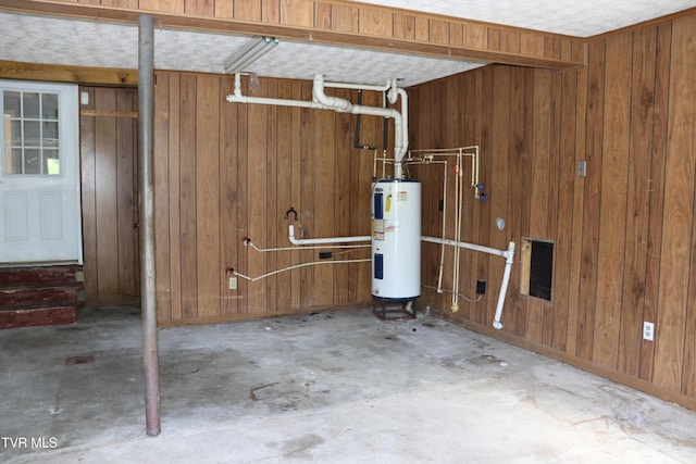 basement with wooden walls and water heater