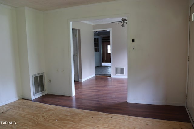 empty room featuring hardwood / wood-style flooring, ceiling fan, and crown molding