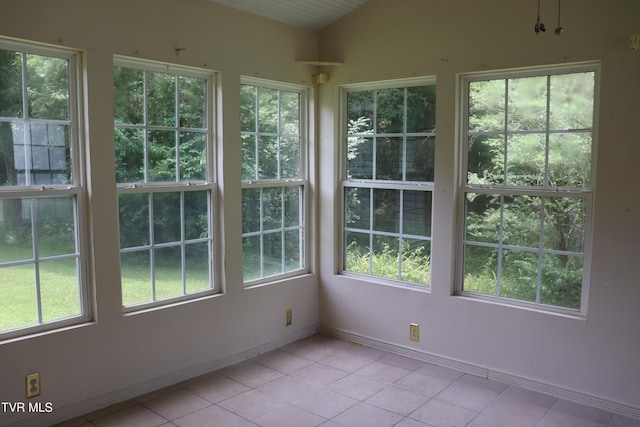 unfurnished sunroom featuring vaulted ceiling