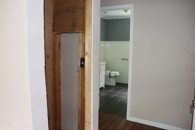 bathroom with hardwood / wood-style flooring and toilet