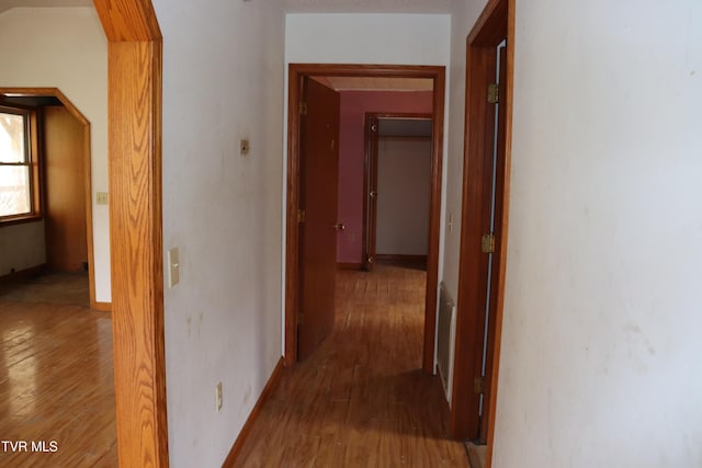 hall with hardwood / wood-style floors