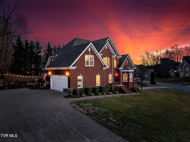 view of front facade featuring a garage and a lawn