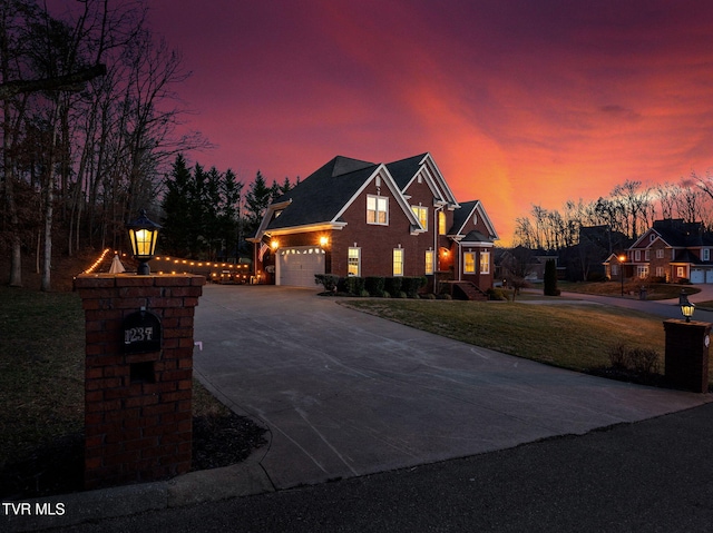 view of front of house with concrete driveway, a front lawn, and an attached garage