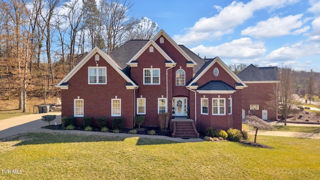 view of front of home with brick siding and a front yard