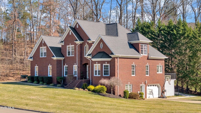 view of front of property with a garage, brick siding, a front lawn, and a shingled roof