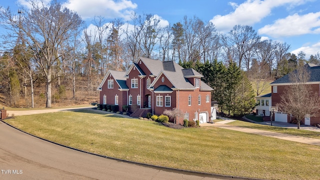 view of front of home with a garage, a front yard, concrete driveway, and brick siding