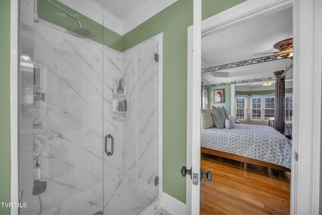 ensuite bathroom with crown molding, a marble finish shower, ceiling fan, ensuite bath, and wood finished floors