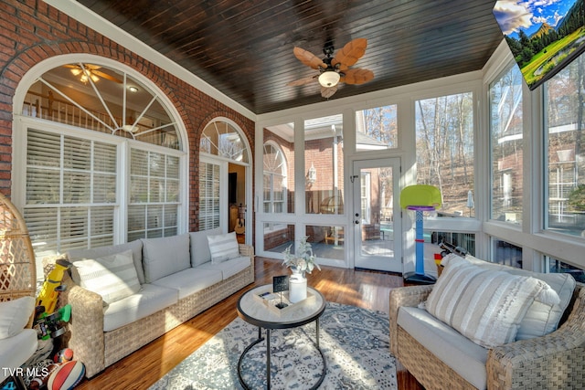 sunroom featuring wooden ceiling, plenty of natural light, and a ceiling fan