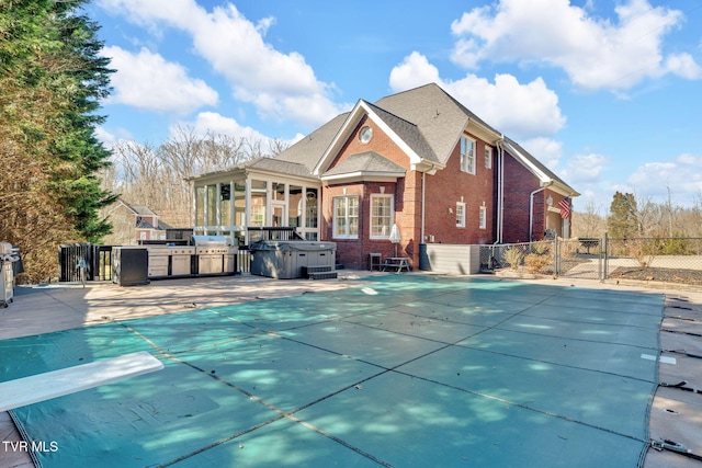 view of pool with a patio, a hot tub, area for grilling, fence, and a diving board