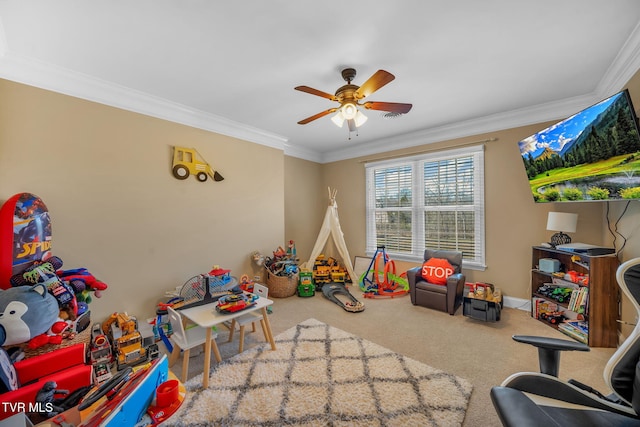 playroom featuring ornamental molding, ceiling fan, carpet floors, and baseboards