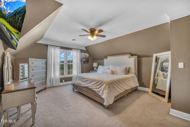 bedroom featuring baseboards, vaulted ceiling, a ceiling fan, and light colored carpet