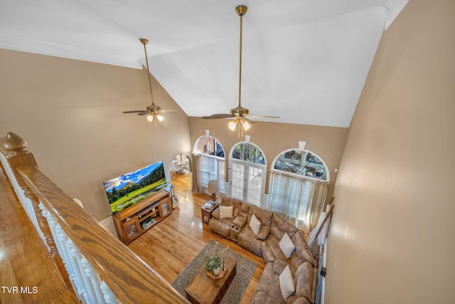 living room featuring high vaulted ceiling and wood finished floors