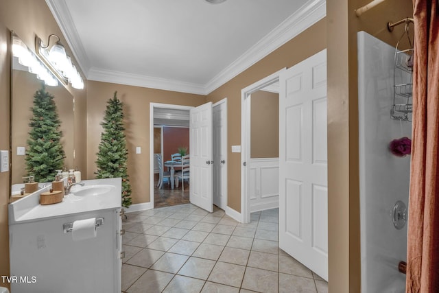 full bath featuring tile patterned flooring, vanity, baseboards, ornamental molding, and a stall shower