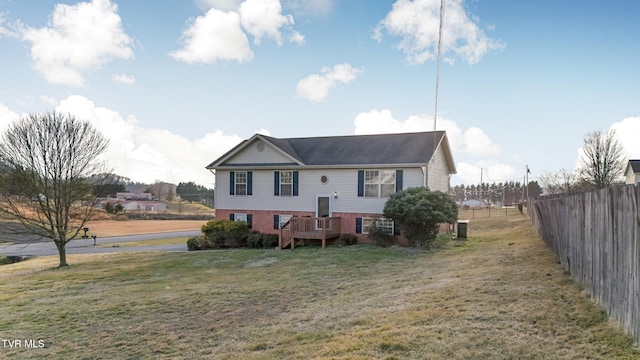 view of front of home with central AC unit and a front yard