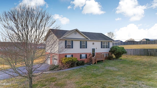 view of front of property with a deck and a front lawn