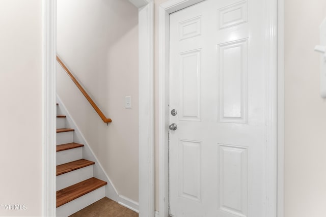 stairway with tile patterned flooring