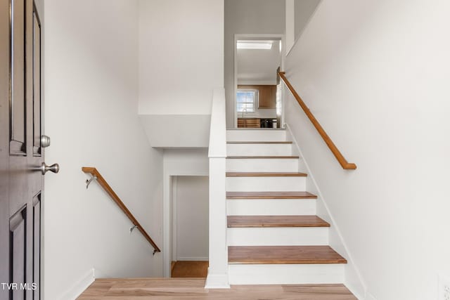 stairs with wood-type flooring