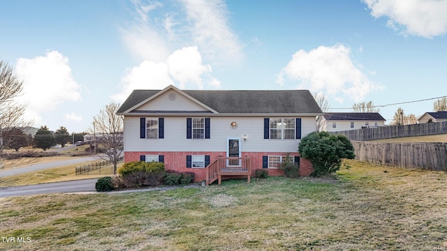 bi-level home with a front lawn