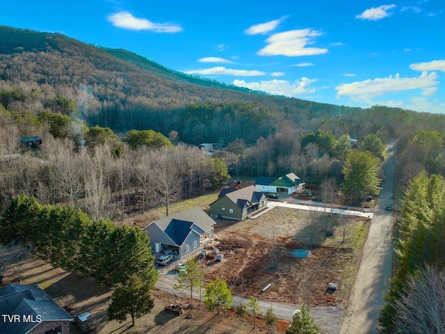 drone / aerial view with a mountain view and a forest view