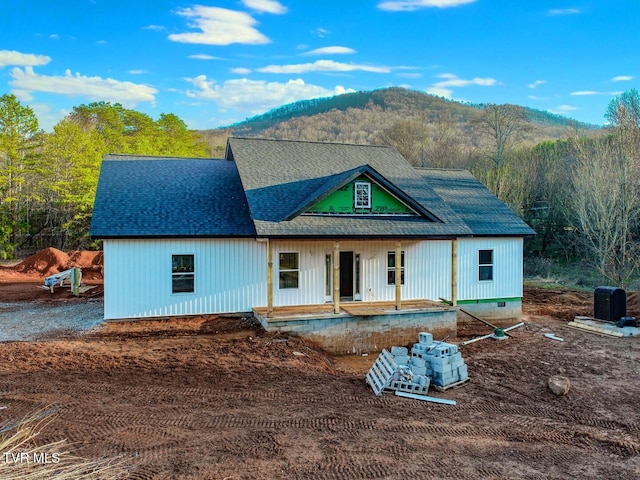 back of property with a mountain view