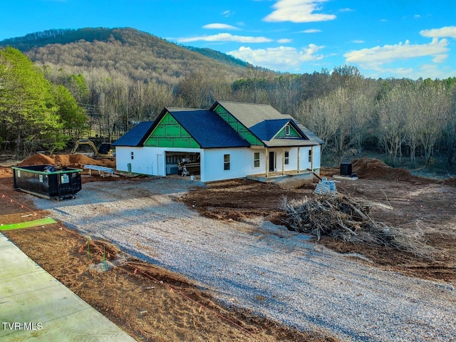 view of front facade featuring a mountain view and a garage