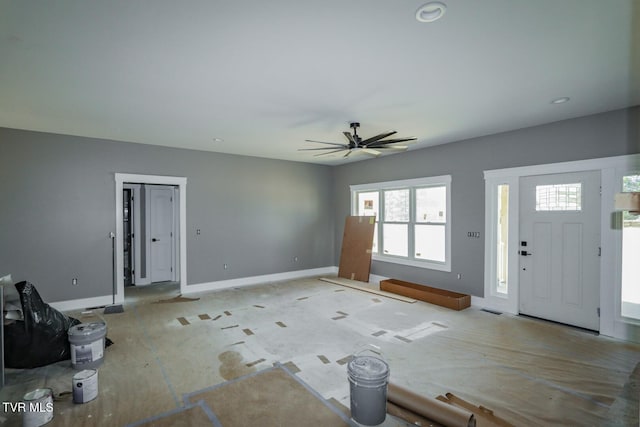 interior space featuring a ceiling fan and baseboards