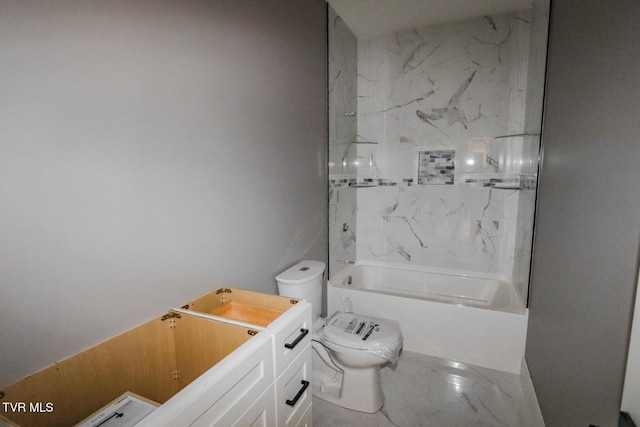 bathroom featuring toilet, marble finish floor, and bathing tub / shower combination