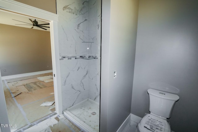 full bathroom with toilet, a marble finish shower, and a ceiling fan