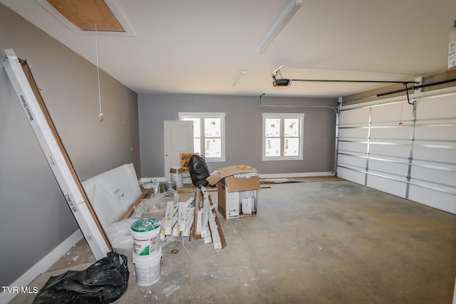 garage with baseboards and a garage door opener