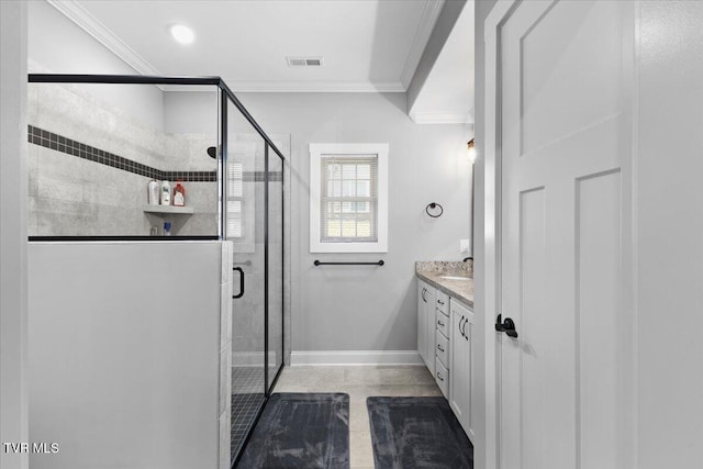 bathroom with ornamental molding, vanity, and a shower with door