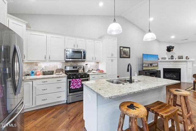 kitchen featuring white cabinetry, pendant lighting, and appliances with stainless steel finishes