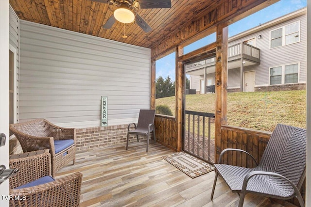 sunroom featuring wood ceiling and ceiling fan