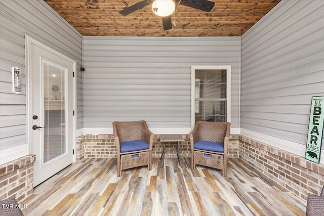 sunroom featuring wooden ceiling and ceiling fan