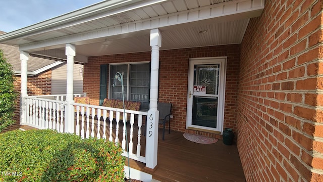 view of exterior entry with a porch