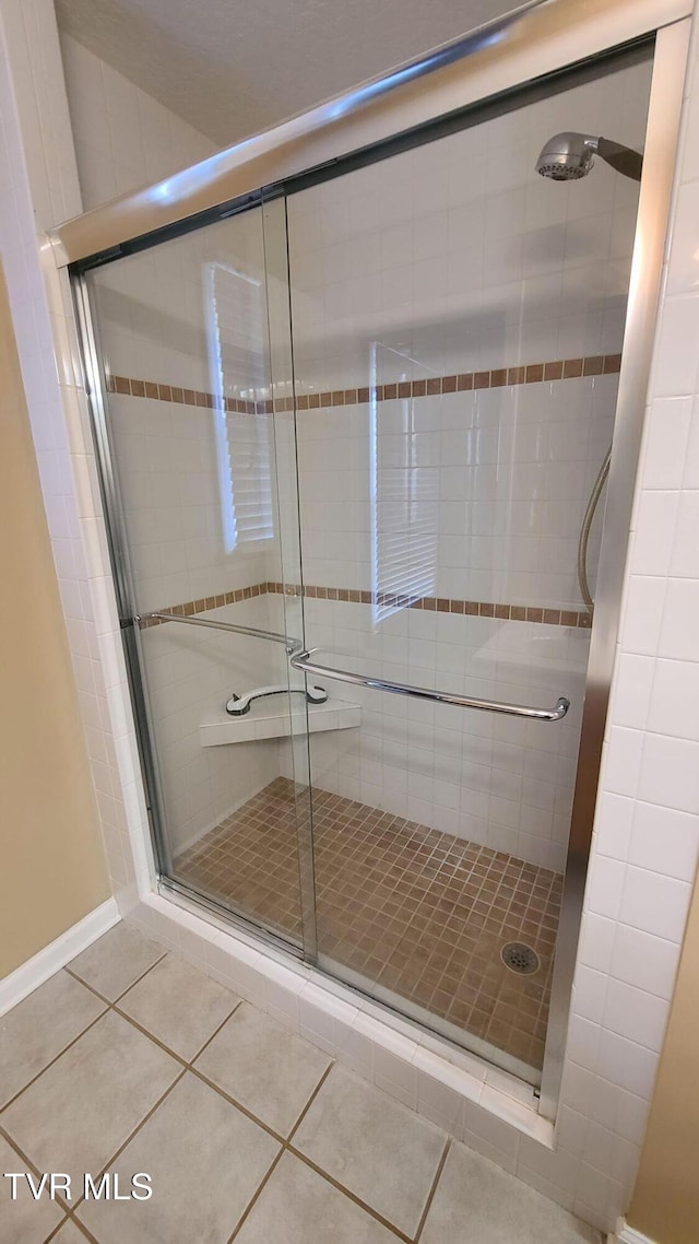 bathroom featuring tile patterned flooring and a shower with door