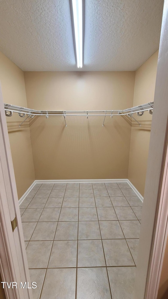 spacious closet featuring light tile patterned floors