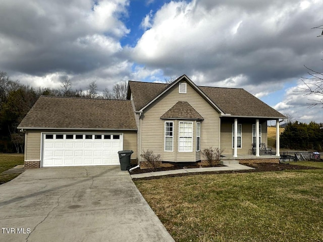 view of front of house with a garage, a front lawn, and a porch