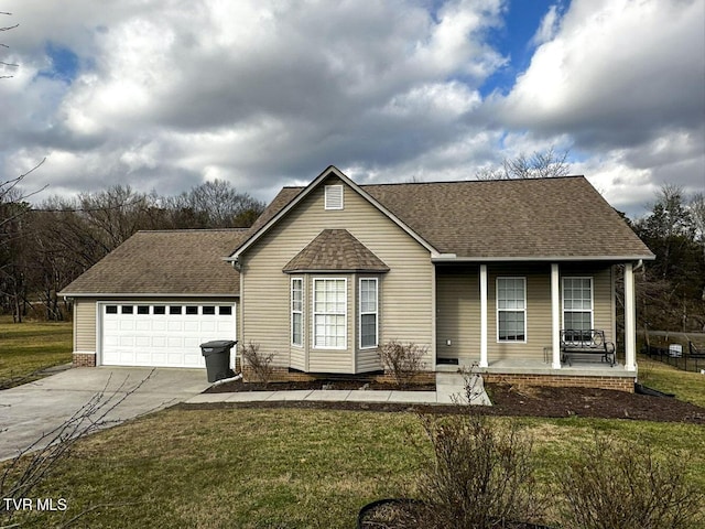 view of front of home featuring a garage, a front lawn, and covered porch