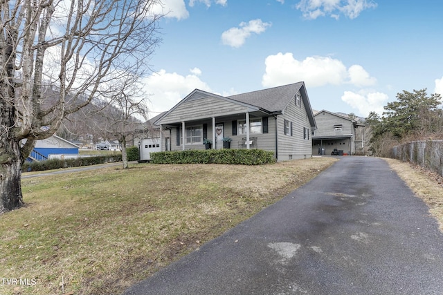 bungalow-style house featuring a garage and a front lawn