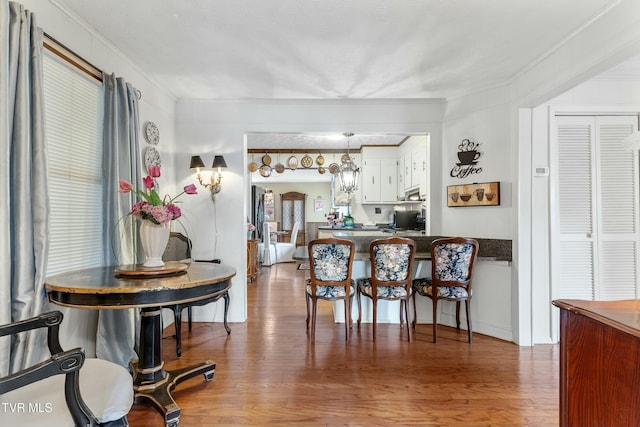 interior space featuring wood finished floors and ornamental molding