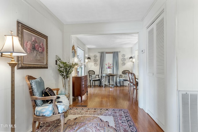 hallway featuring visible vents and wood finished floors