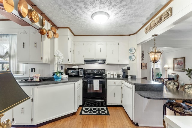 kitchen with black electric range, dark countertops, a peninsula, exhaust hood, and dishwasher