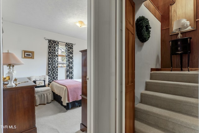 bedroom with carpet floors and a textured ceiling