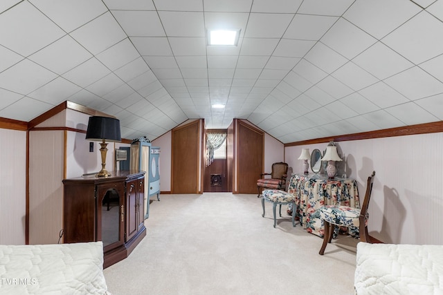 interior space with light colored carpet, wood walls, and vaulted ceiling